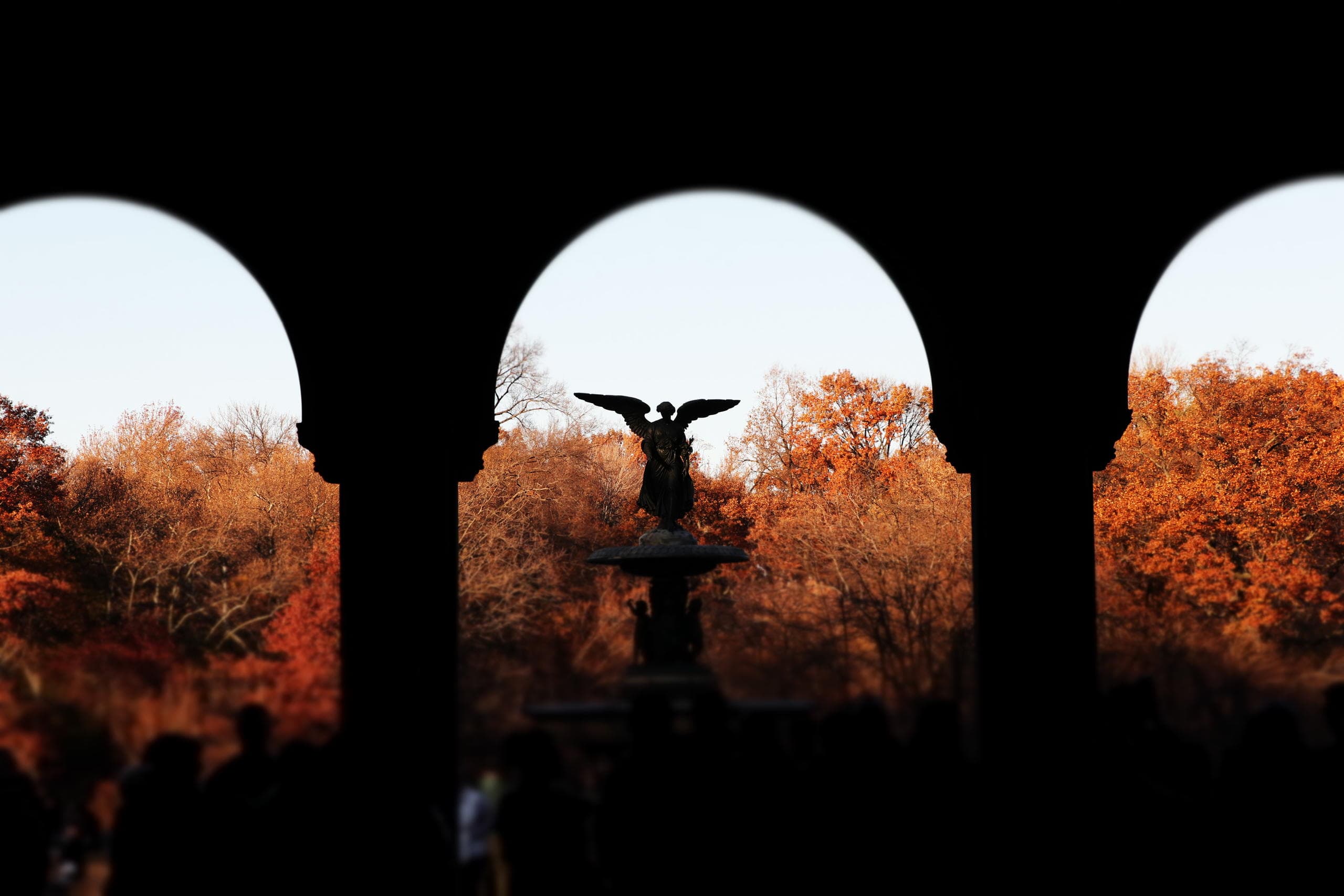 Bethesda Fountain framed by arch silhouettes in Central Park