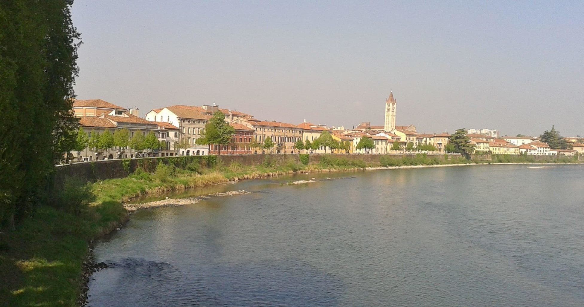Tranquil riverside town vista in Verona showcasing riverbank strolls