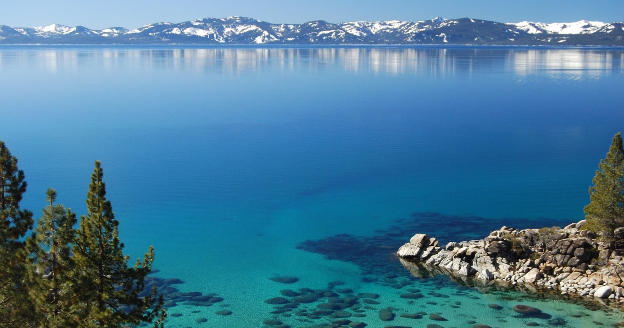 Panoramic Lake Tahoe vista with snowy peaks and crystal water