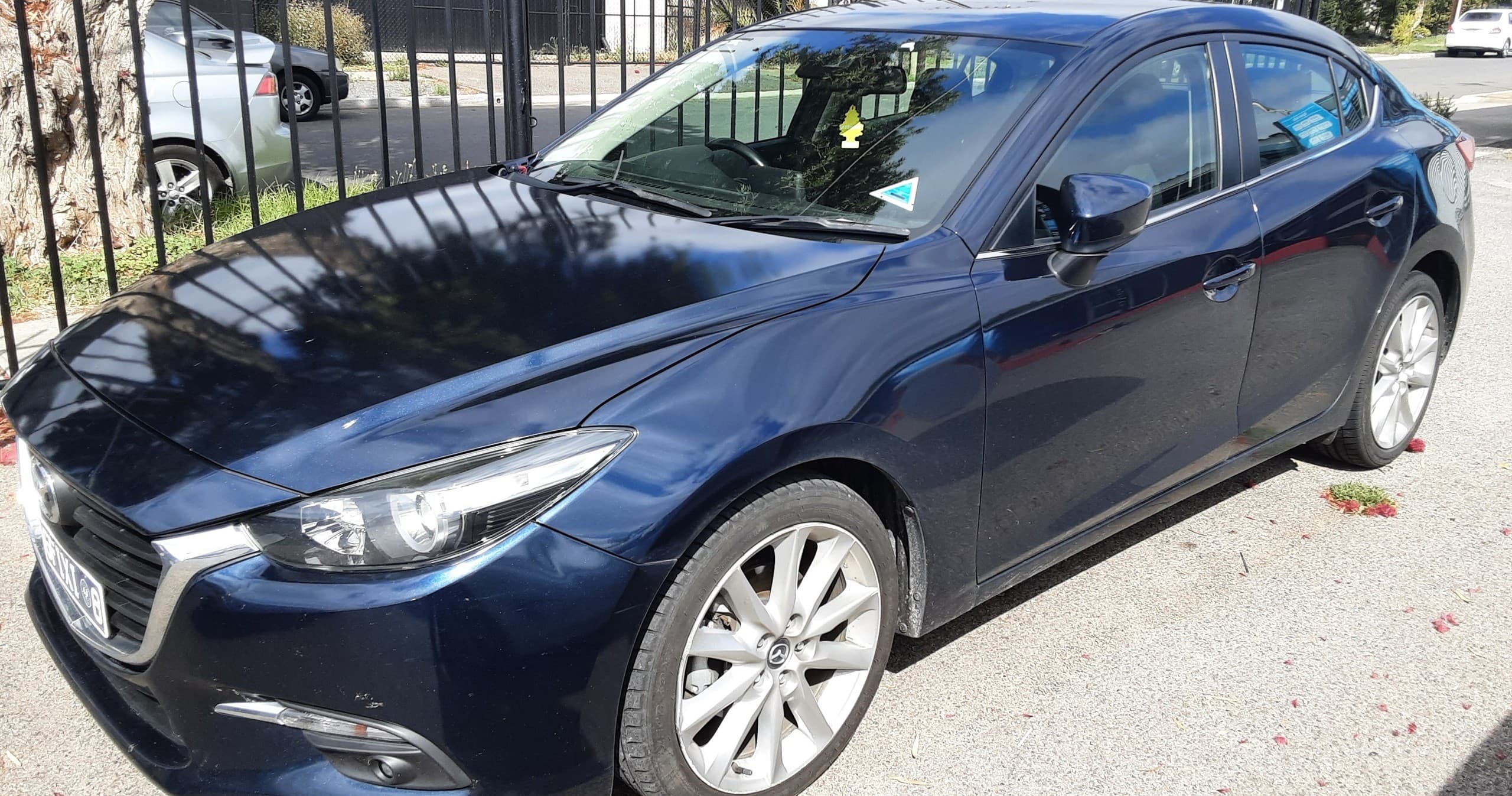 Dark blue sedan parked outdoors, suitable for self-drive road trips
