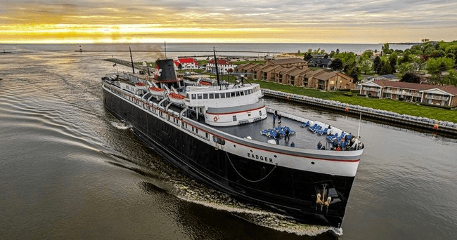 Aerial view of SS Badger ferry cruising Lake Michigan at sunrise