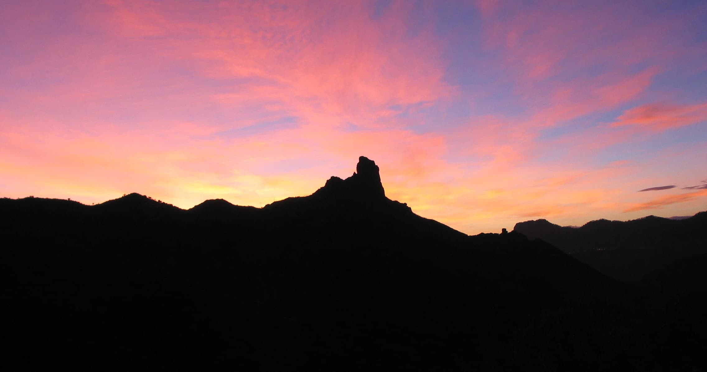 Sunset silhouette of volcanic peak on Gran Canaria ridge