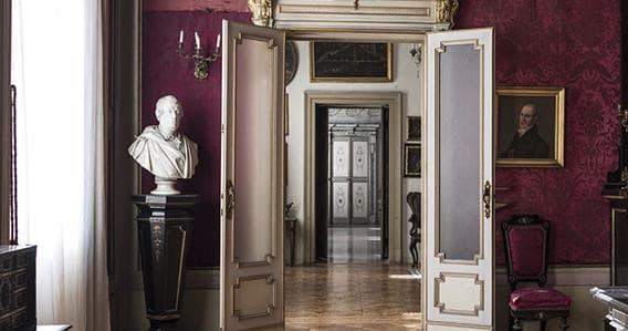 Exploring ornate museum interior with classical busts in Mantua