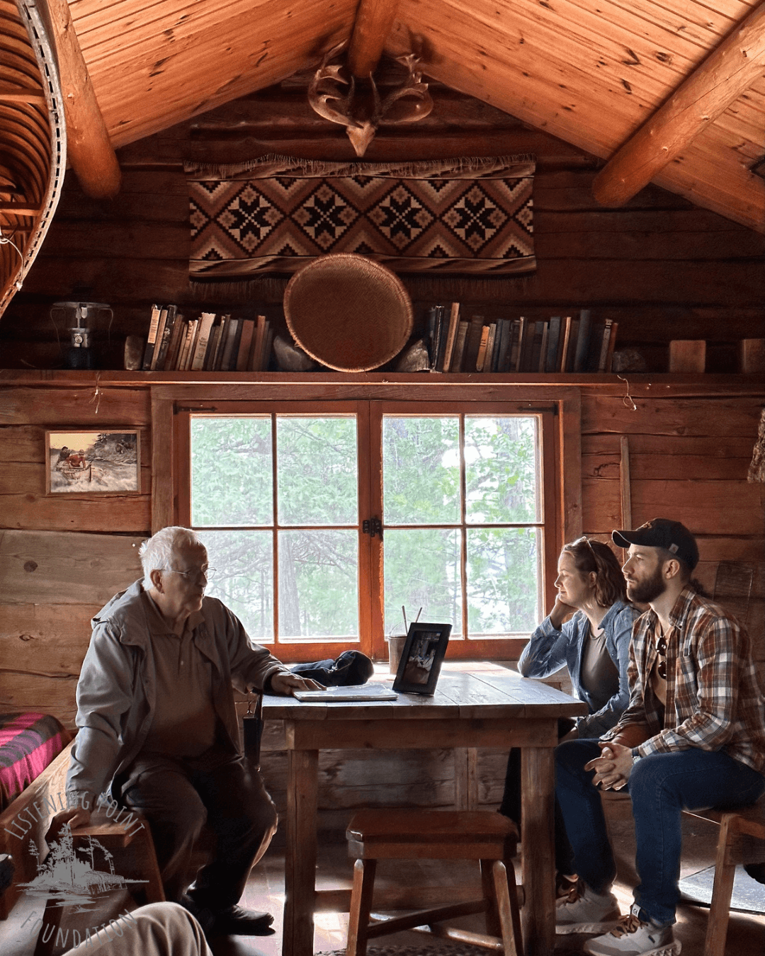 Family conversation inside rustic wooden cabin meeting space