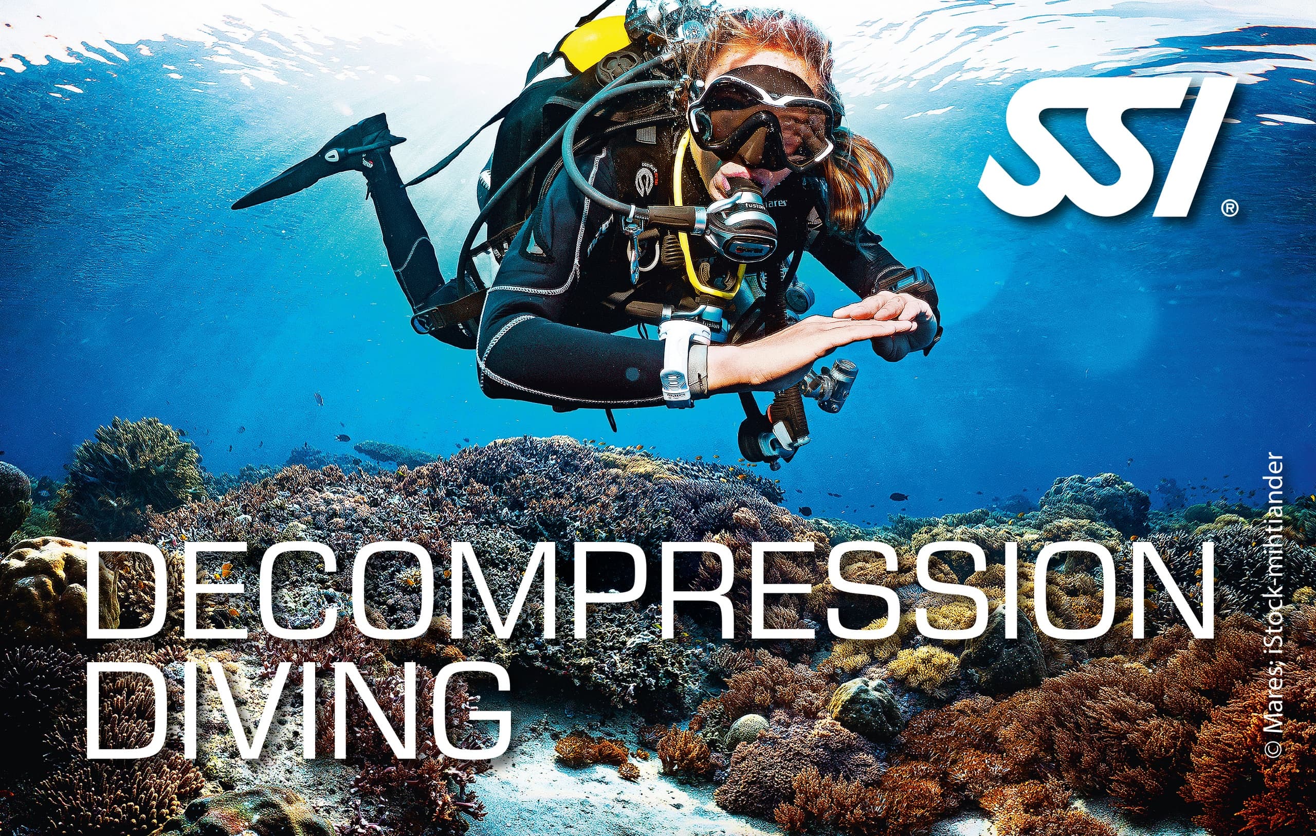 Scuba diver hovering over coral reef during decompression stop
