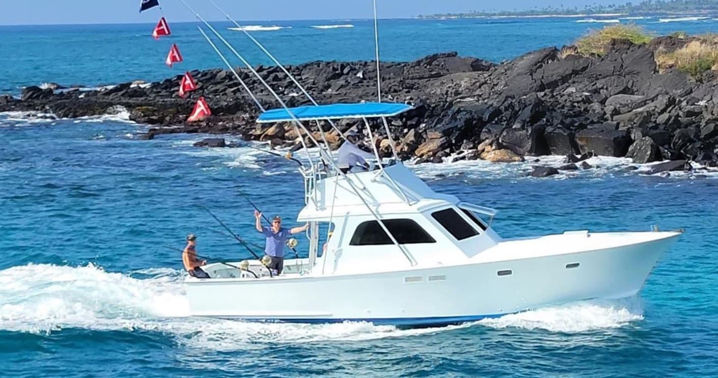 Sportfishing boat cruising turquoise Pacific waters off Kona