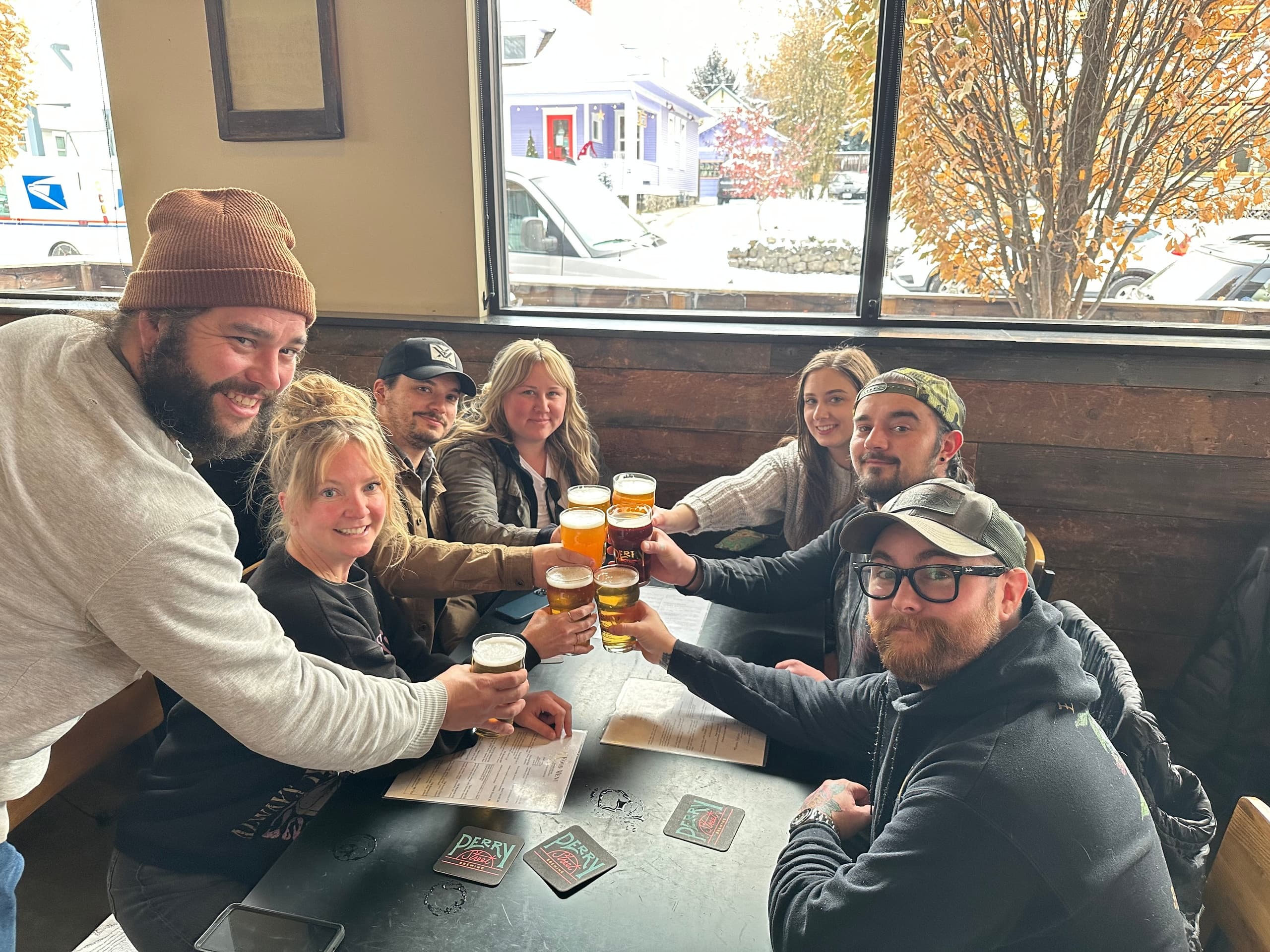 Group enjoying craft beers at brewery taproom with window view