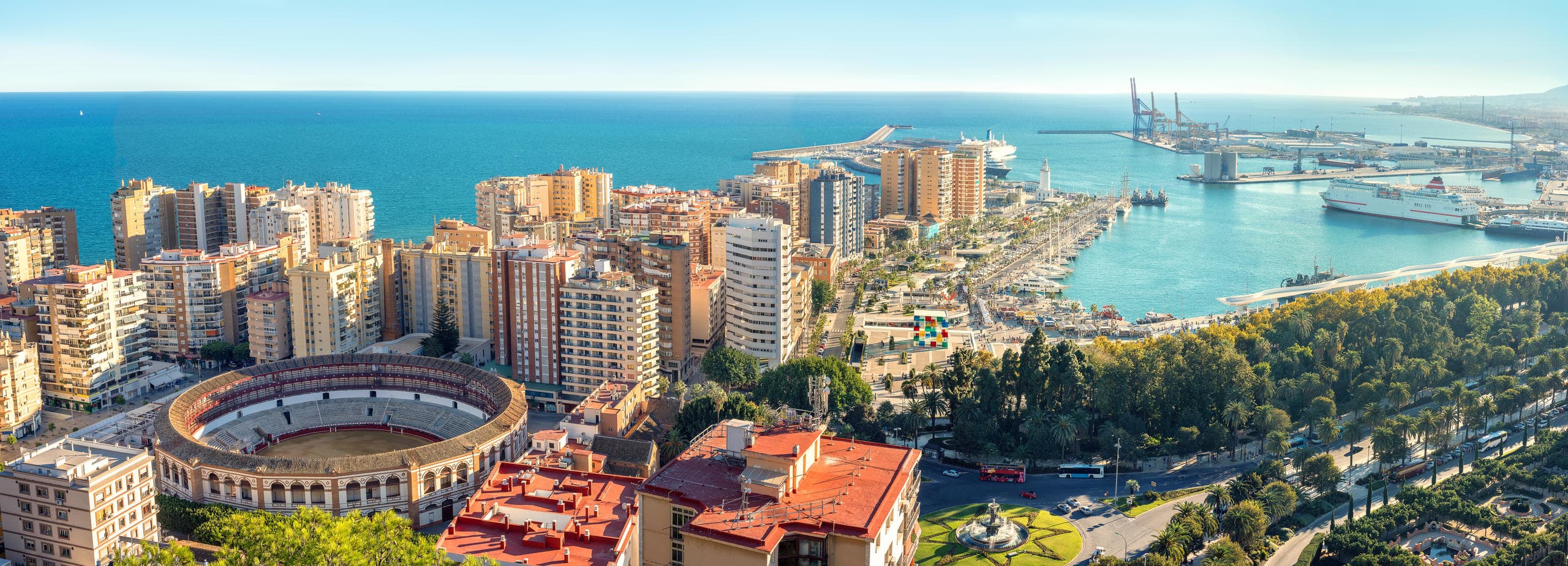 Aerial coastal panorama of Málaga harbor and beach skyline