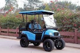 Blue two-row Moke on suburban road framed by trees and fence