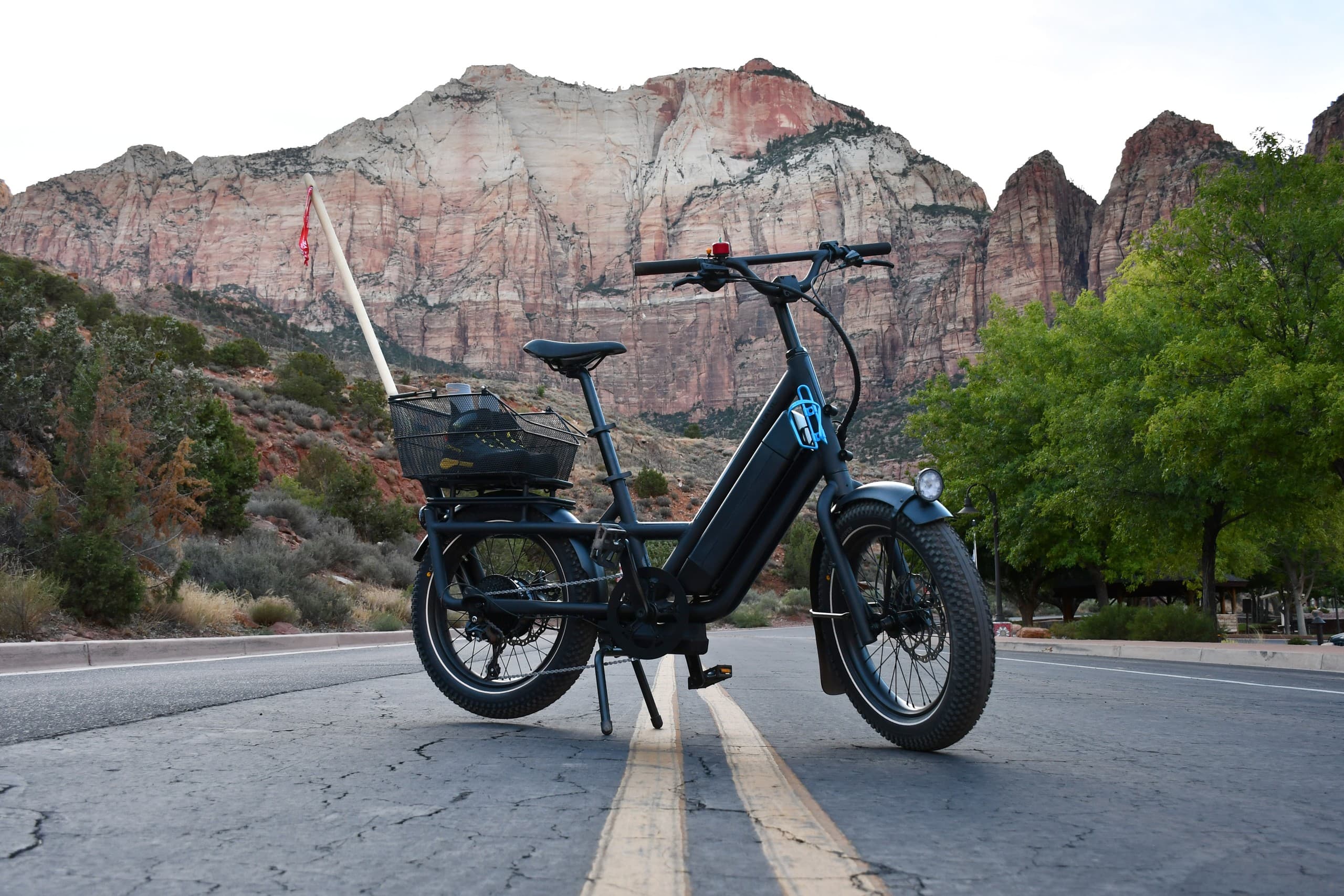 Cargo e-bike parked on road with towering Zion canyon backdrop