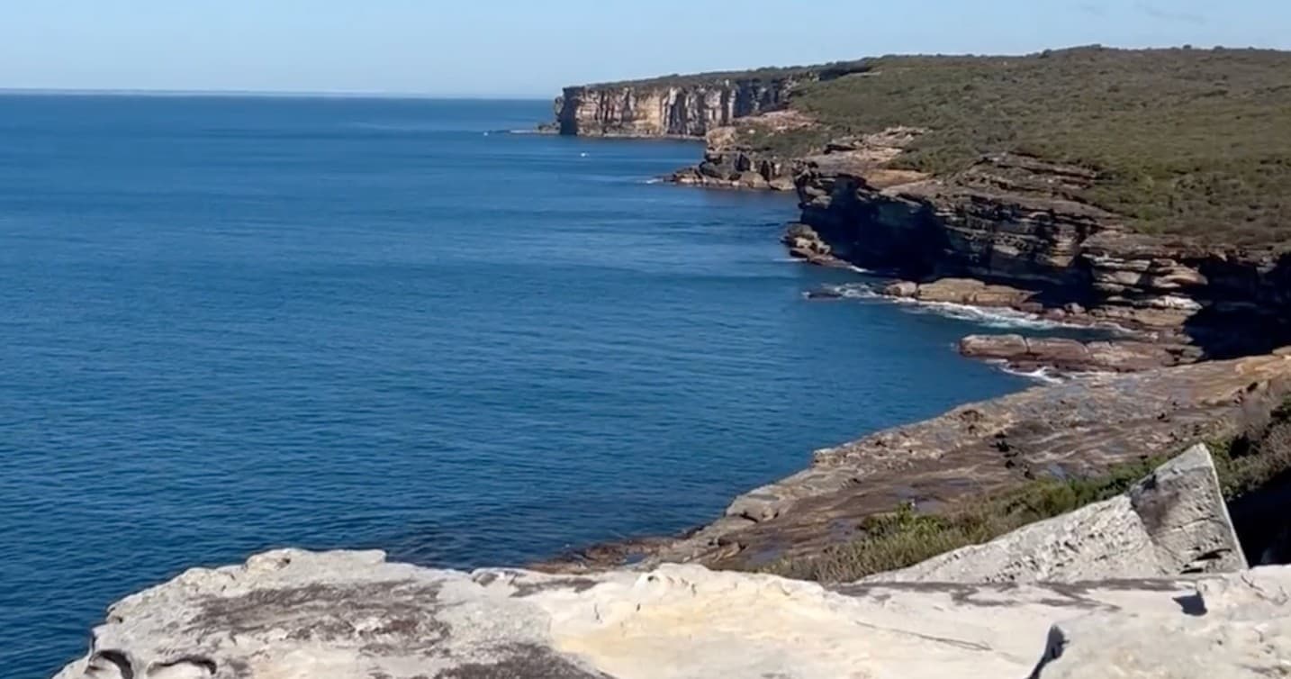 Cliffside coastal viewpoint over blue ocean, seaside hiking vista