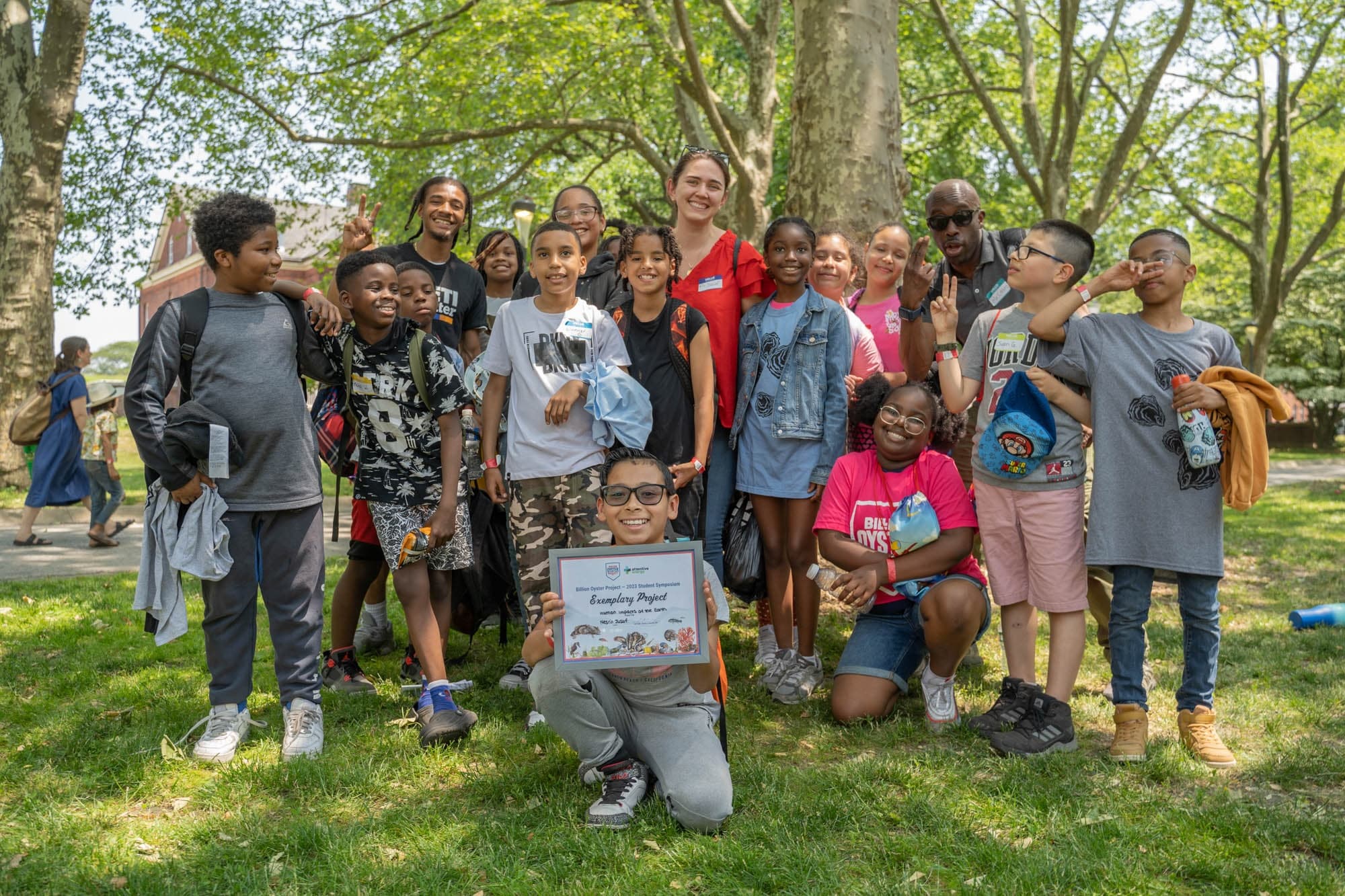 Youth volunteers planting oysters at urban park shoreline
