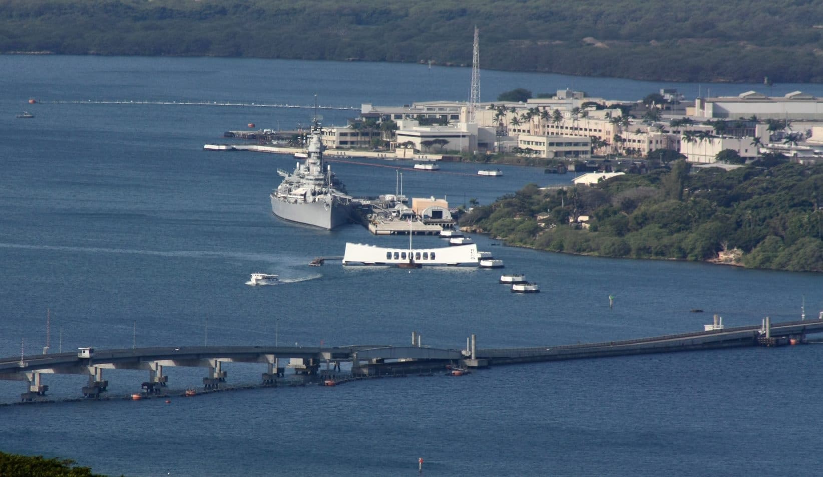 Harbor and pier with anchored vessels in coastal bay town view