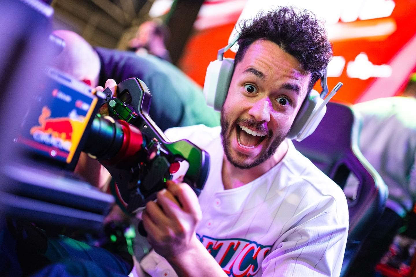 Man excited in indoor racing simulator at esports event