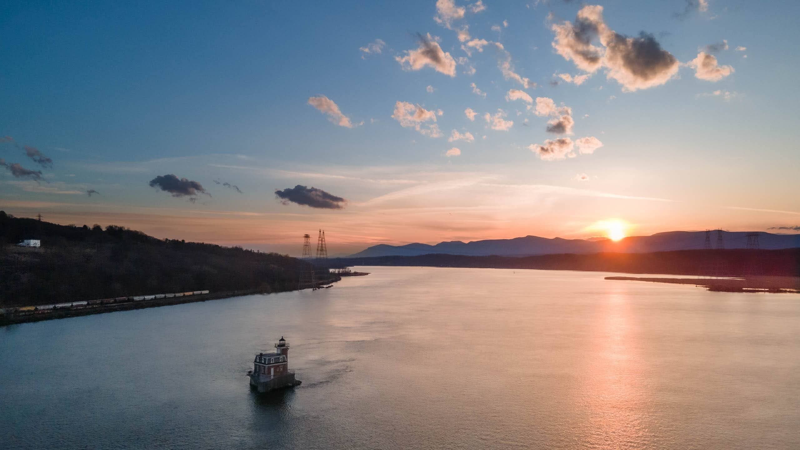 Sunset ferry cruising on the Hudson River, wide scenic vista