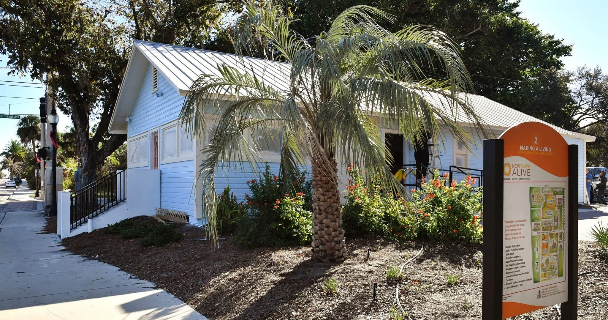 Historic white cottage with palm tree at Sarasota outdoor heritage site
