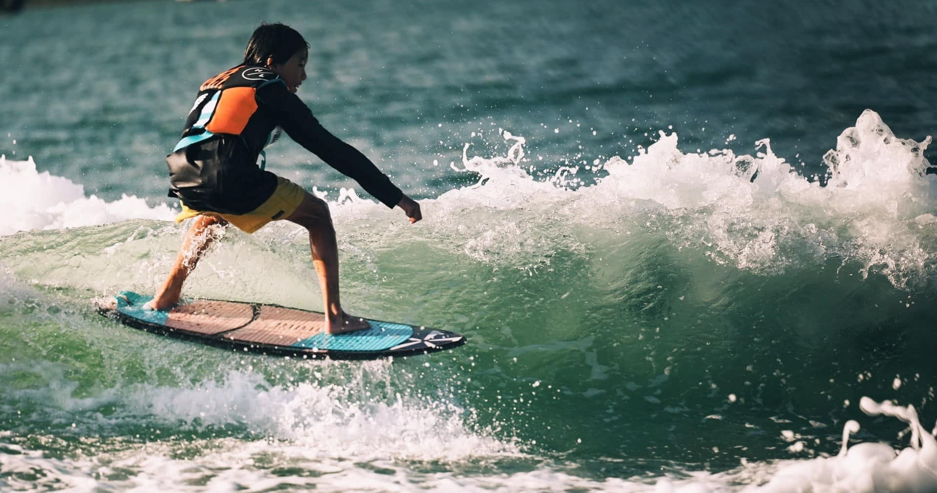 Surfer riding ocean wave near shore, energetic coastal surf action