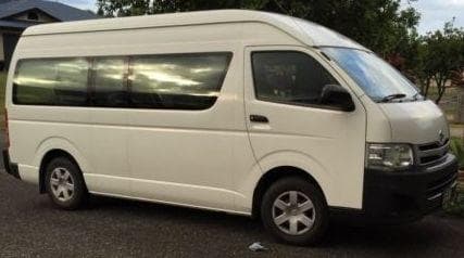 Long wheelbase passenger van parked outdoors for group transfers