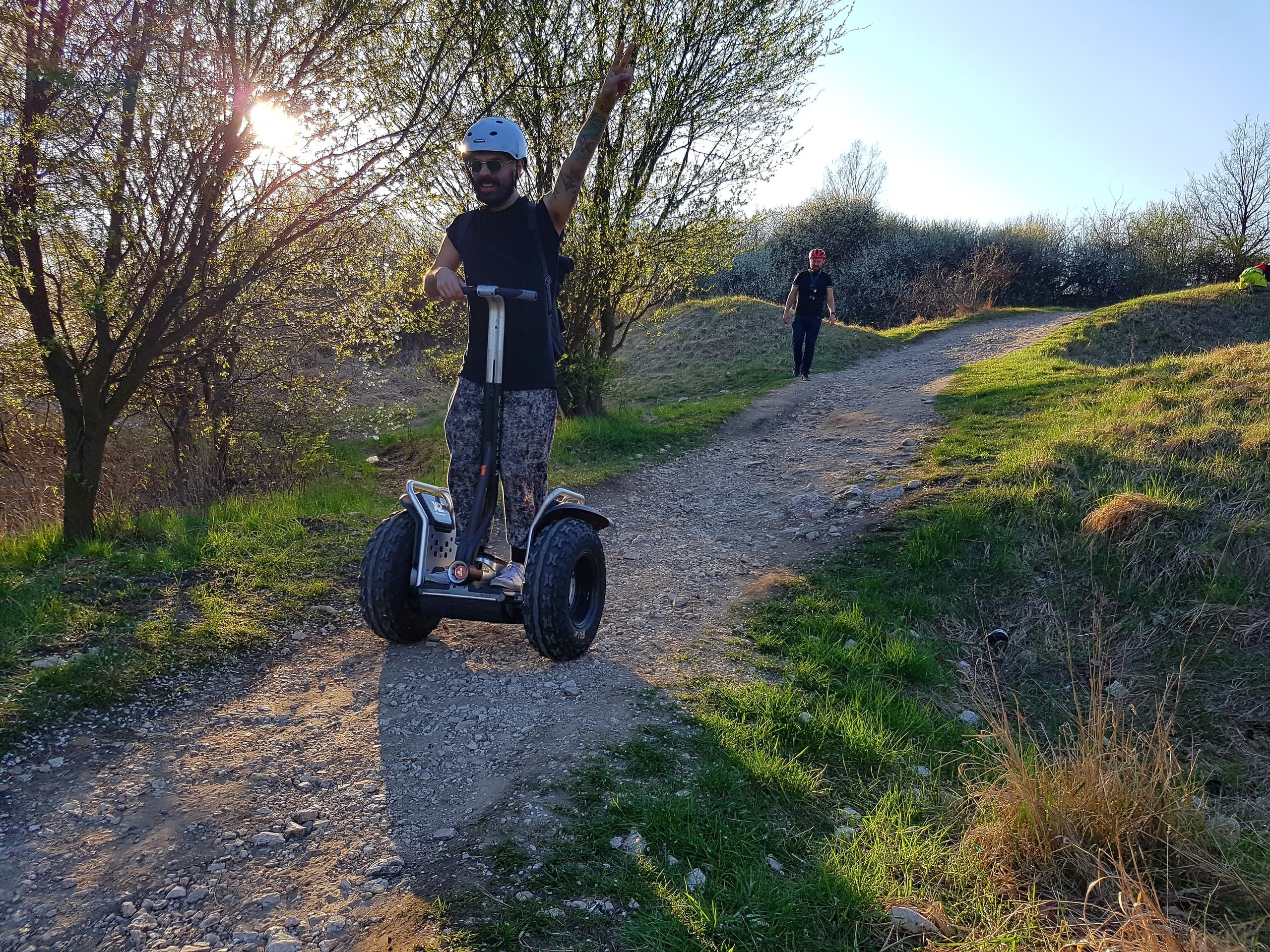 Segway rider on sunlit gravel trail near Krakow countryside