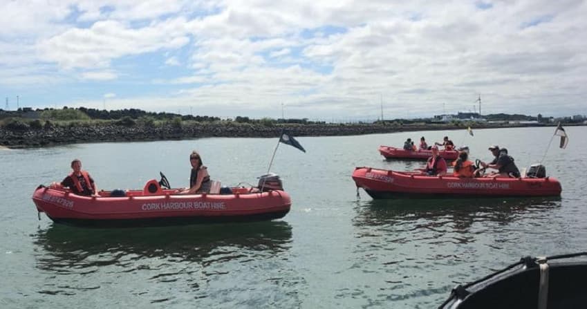 Red RIB boats guiding Cork Harbour scenic boat tours near shore