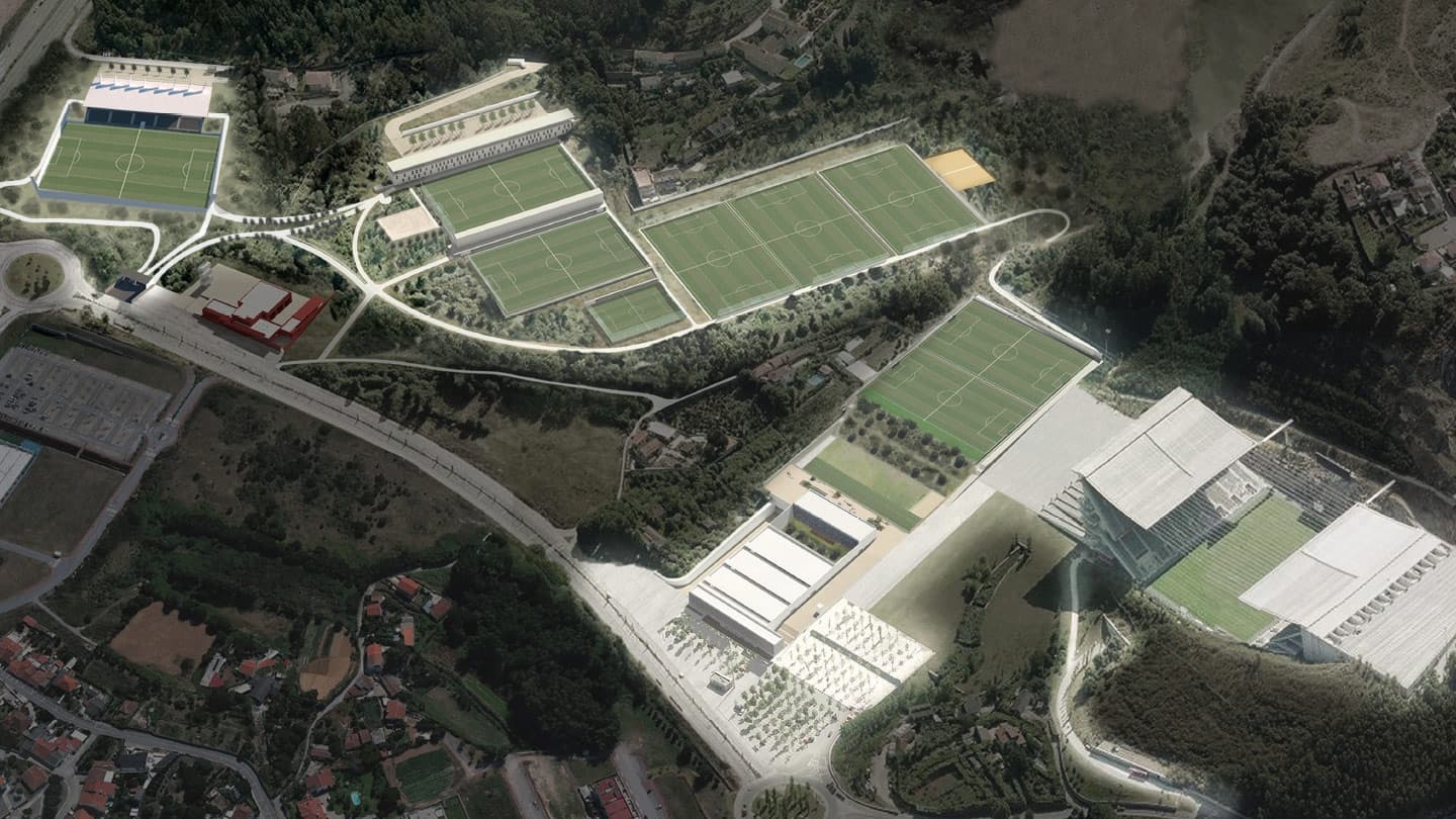 Aerial view of multiple soccer training fields on forested hillside