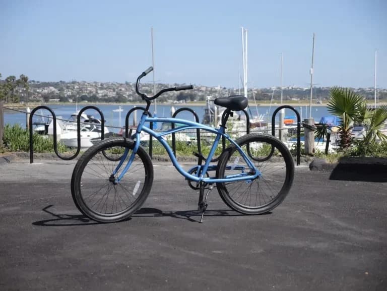 Blue beach cruiser bike parked near marina waterfront at Campland