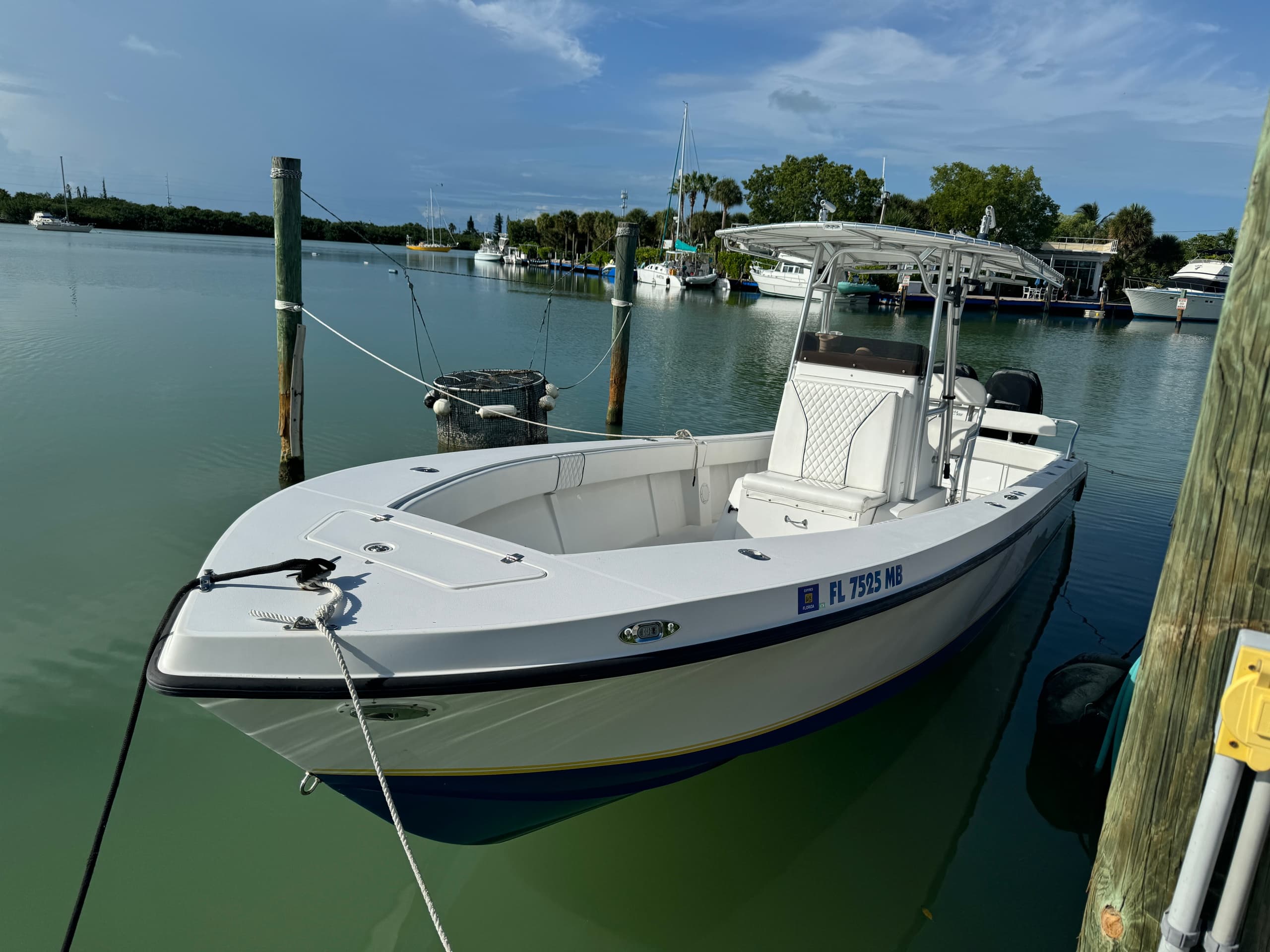Center console fishing boat docked in calm marina waters