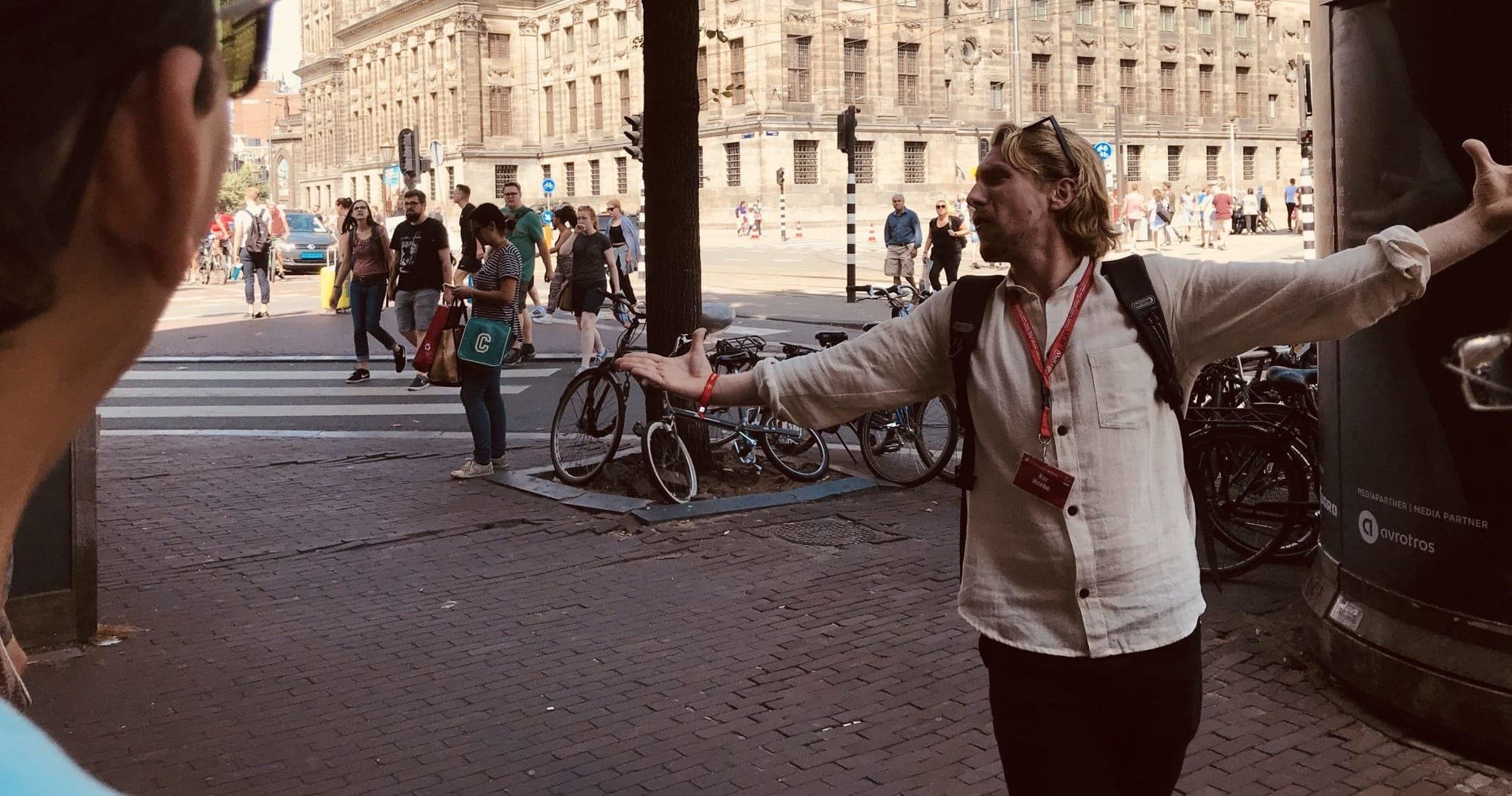 Tour guide gesturing to city sights on DC street tour