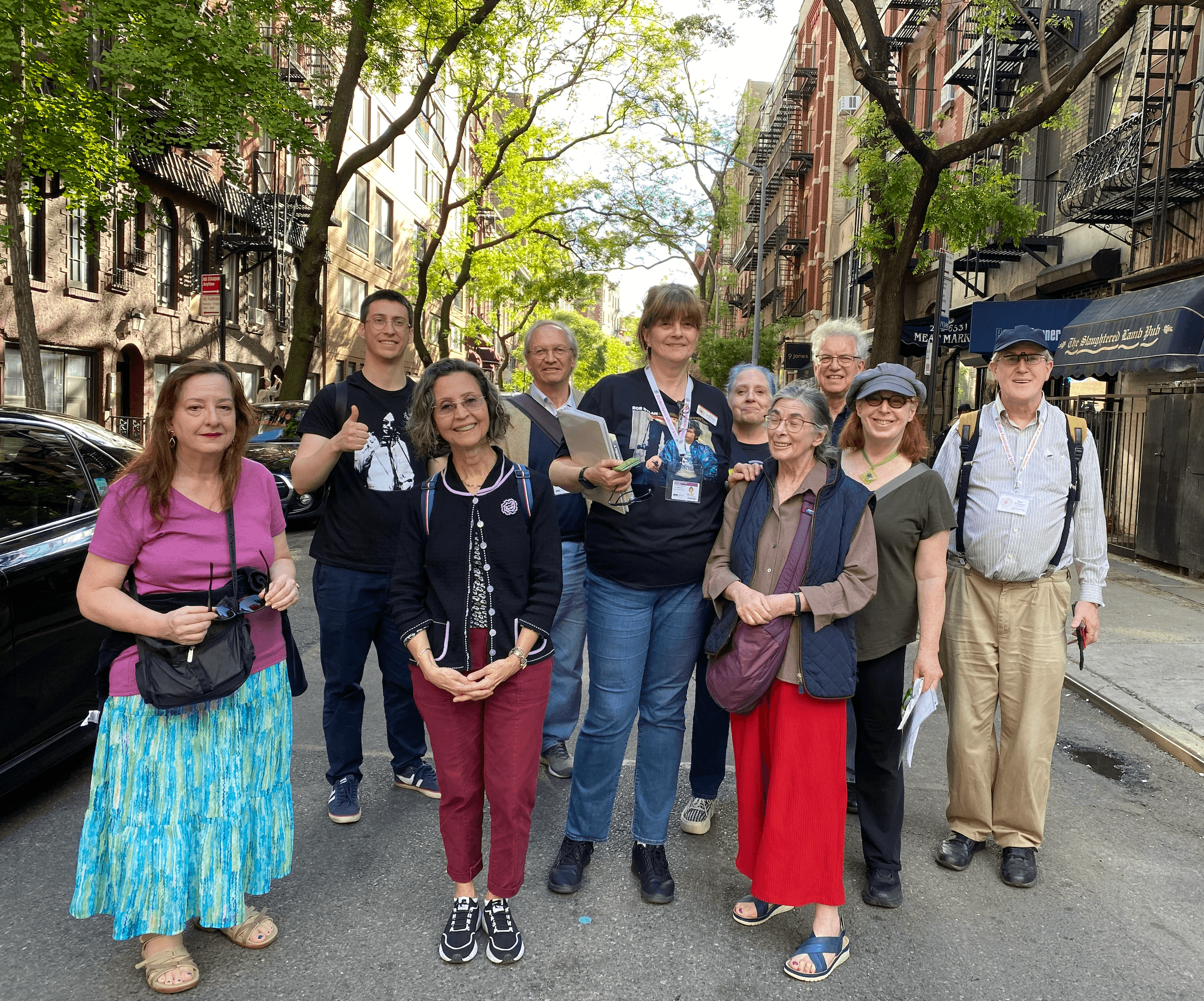 Group walking tour on tree-lined Manhattan street, NYC