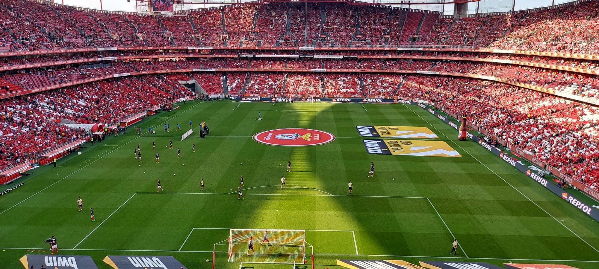 Aerial view of packed soccer stadium hosting match, fan atmosphere