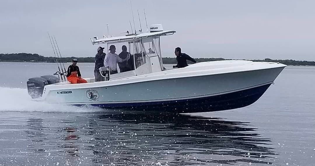 High-speed sportfishing boat cutting through open ocean