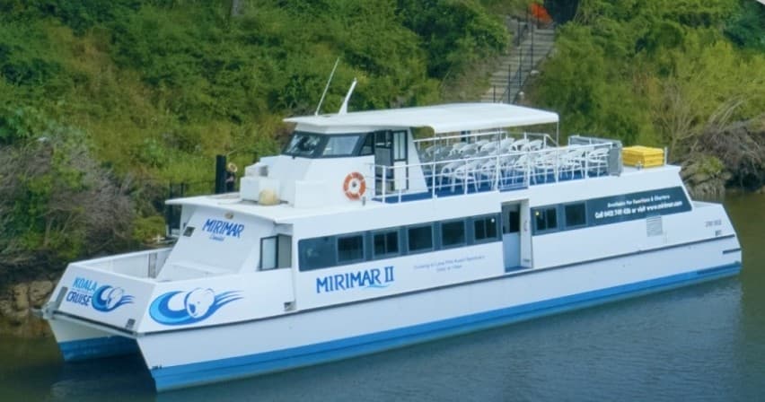 Double-decker catamaran cruise on calm river for sightseeing