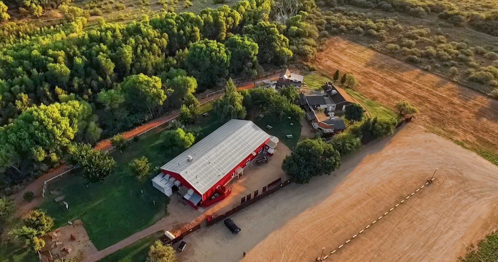 Aerial view of Blazin M Ranch showing barns and oak landscape