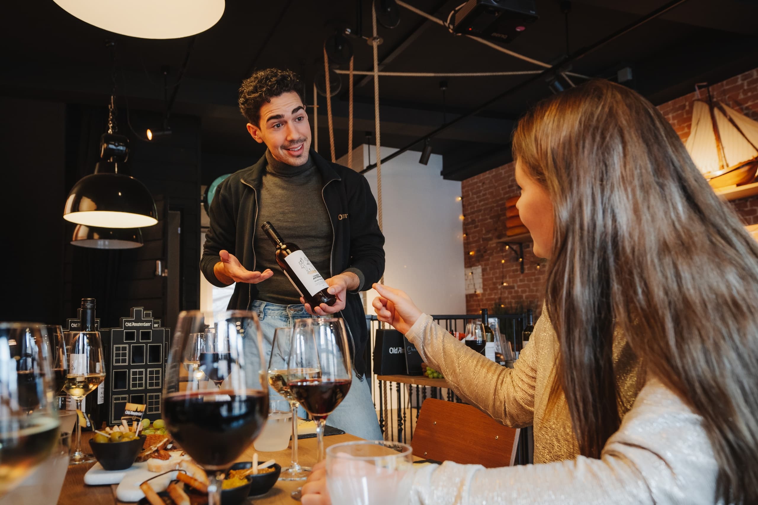 Indoor cheese tasting with wine at cozy cafe/restaurant table