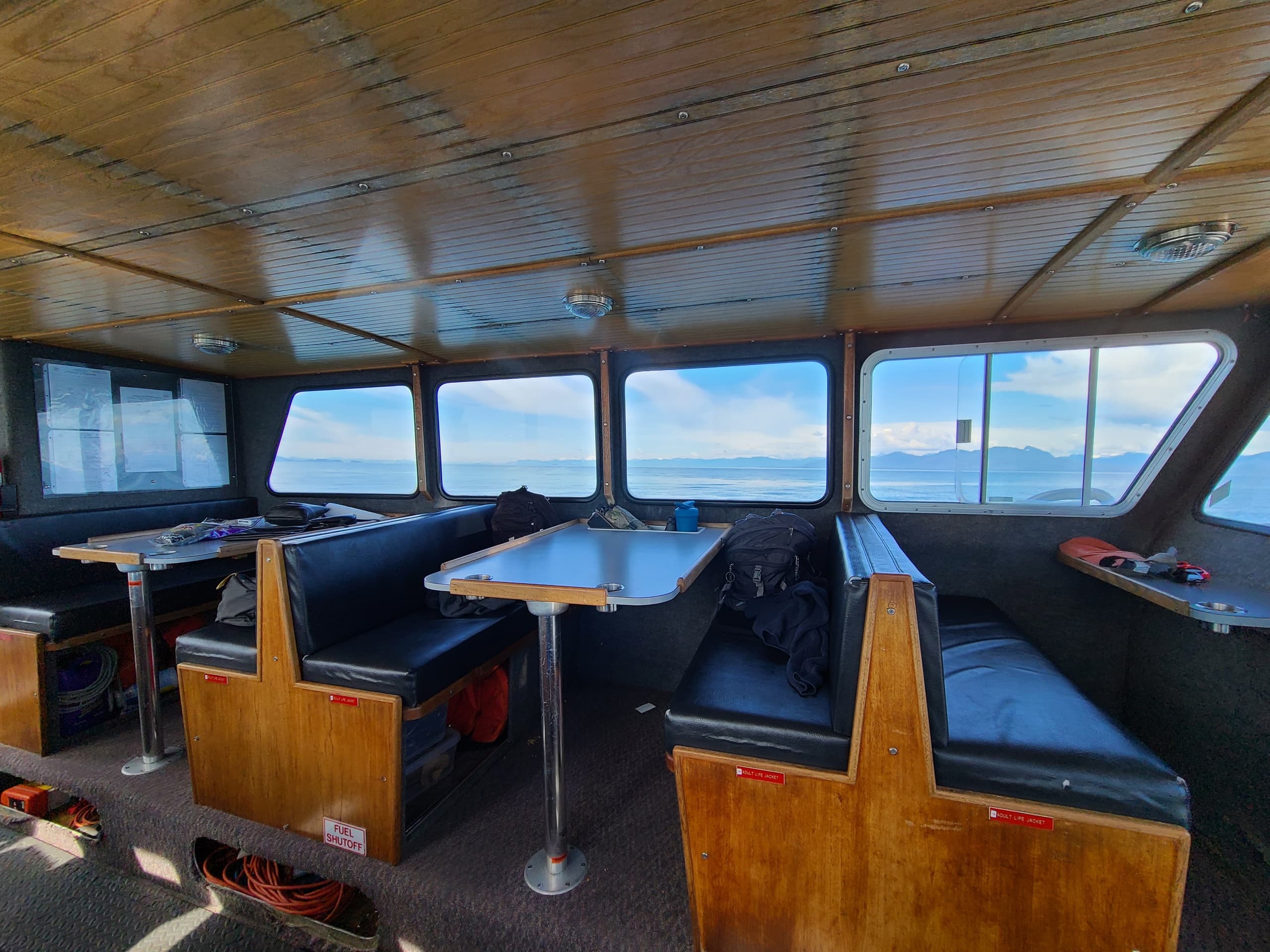 Boat cabin interior with seating and panoramic windows on cruise