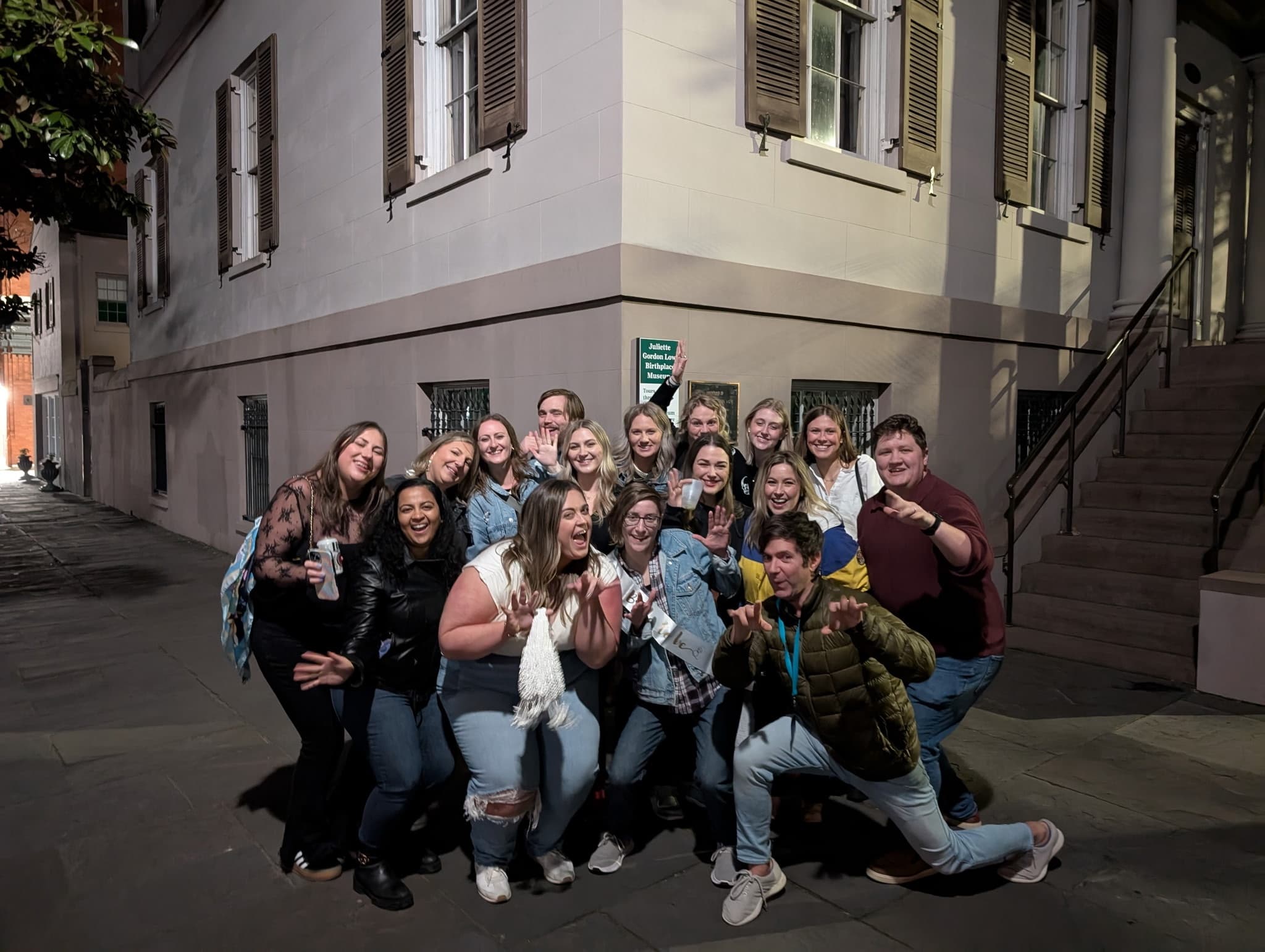 Tour group posing on quiet Savannah street corner during evening tour