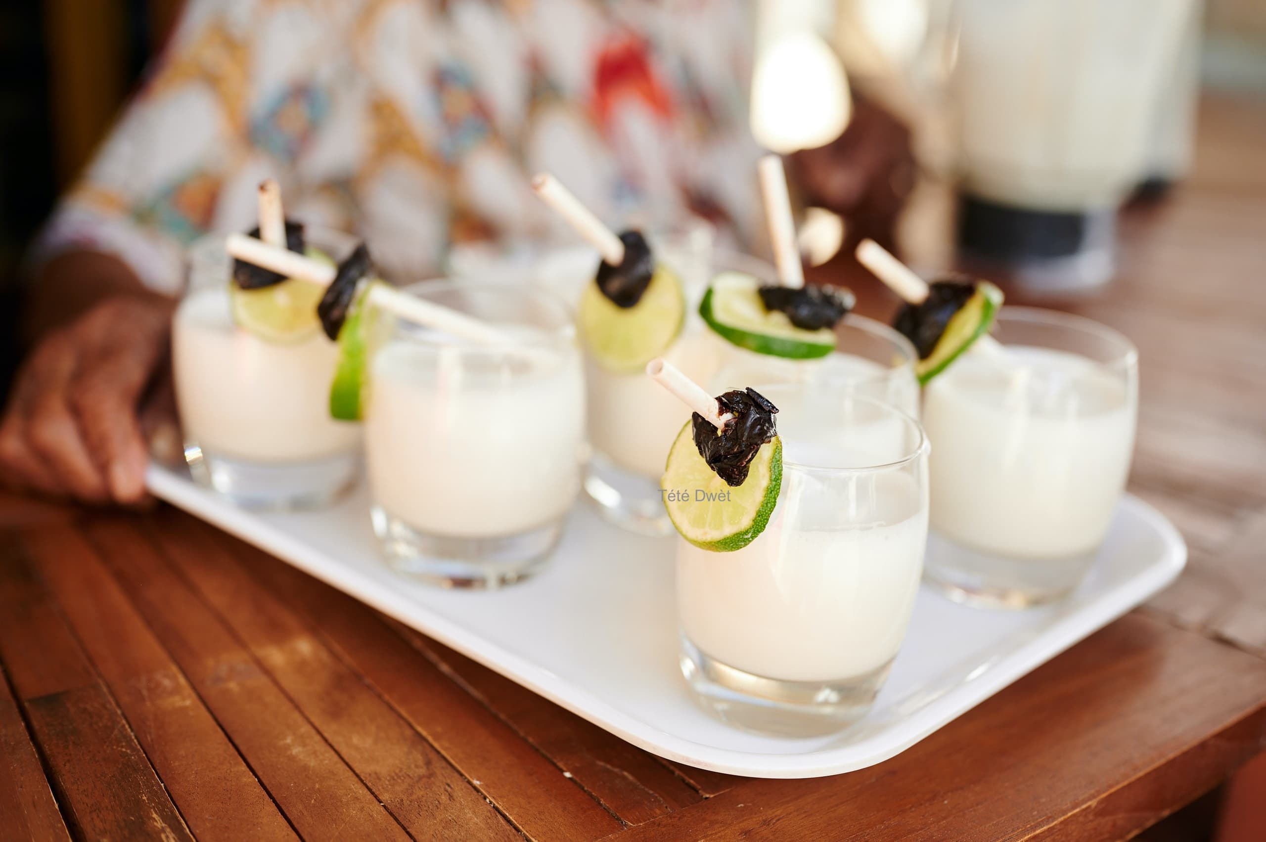 Cocktail flight with creamy drinks garnished with lime at beachfront bar