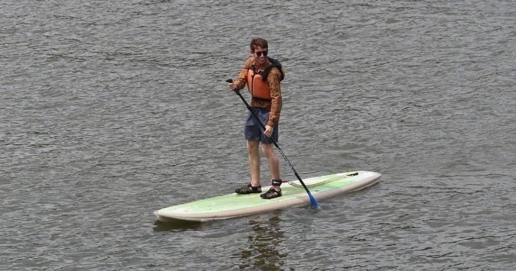 Stand-up paddleboarding on calm harbor waters at The Wharf