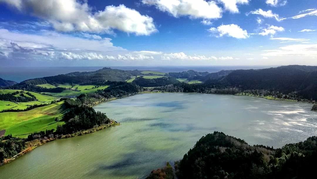 Aerial view of rolling green lagoons and hills in the Azores