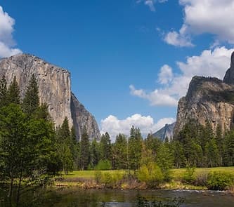 Hikers exploring Yosemite Valley granite cliffs and meadows