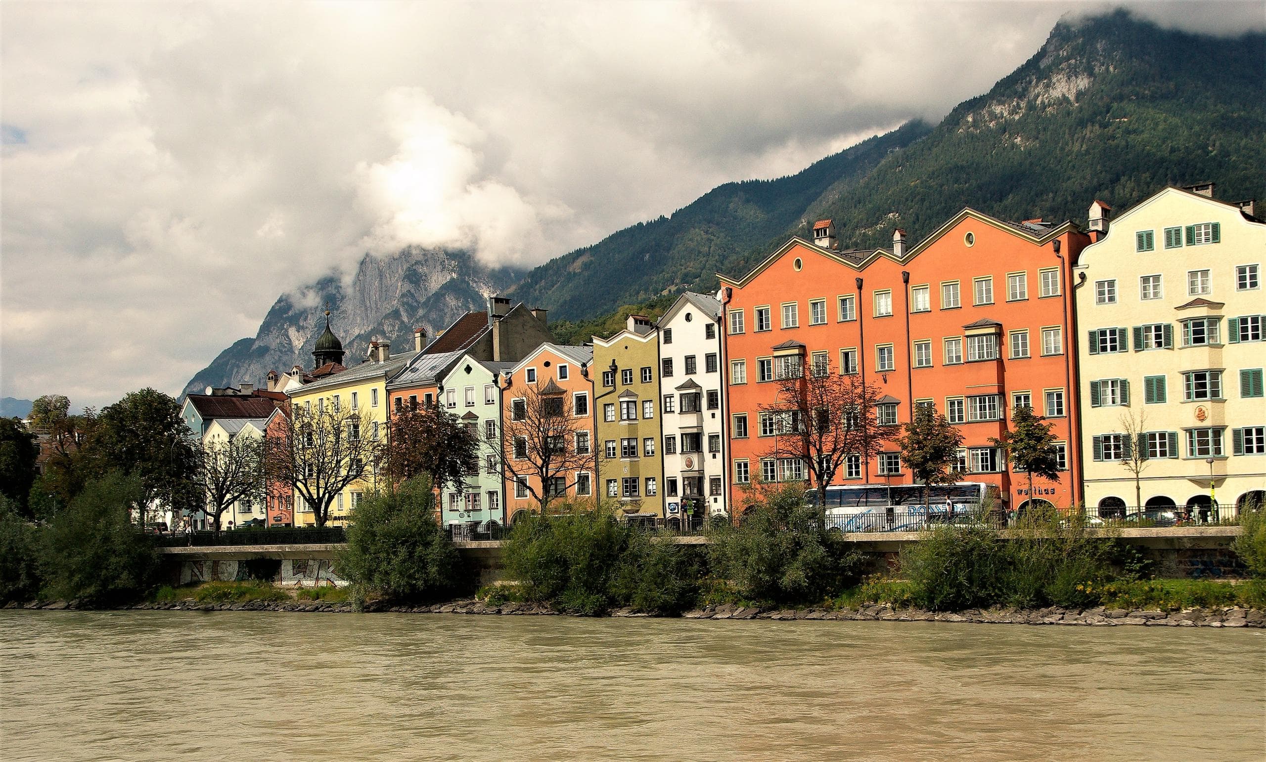 Colorful riverside buildings along alpine river in European town