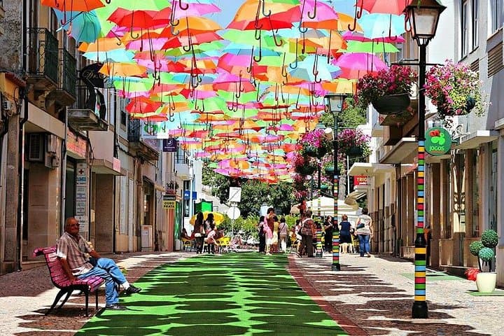 Private Coastal Journey from Lisbon: Óbidos, Nazaré & Águeda Umbrella Sky