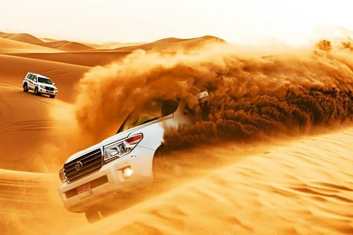 Evening Dubai Desert Safari: Dune Bashing, BBQ Dinner & Seven Live Shows