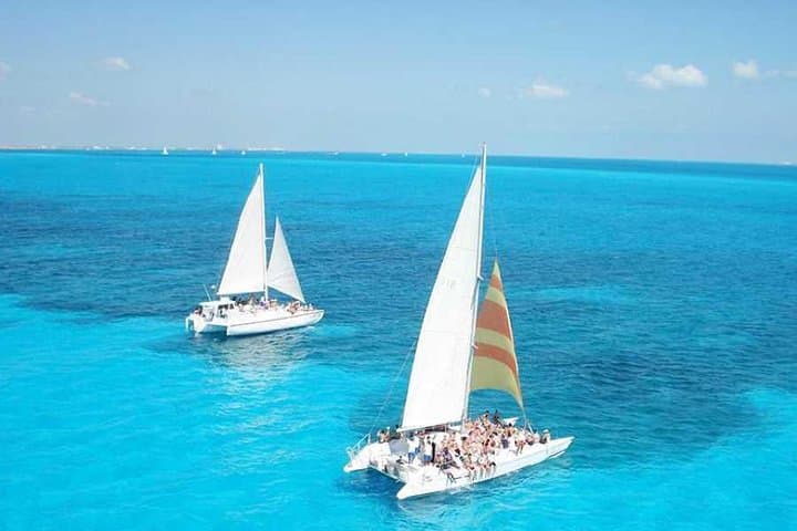 Luxury Catamaran to Isla Mujeres: Snorkel, Beach Club & Open Bar Day Trip