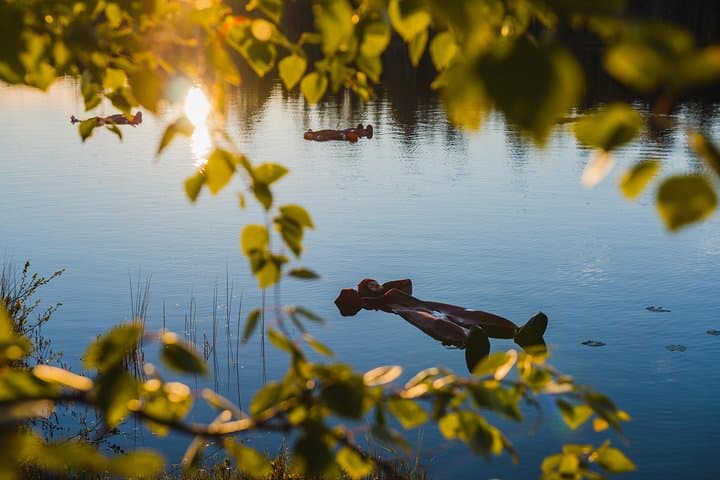 Midnight Sun Floating on an Arctic Lake near Rovaniemi