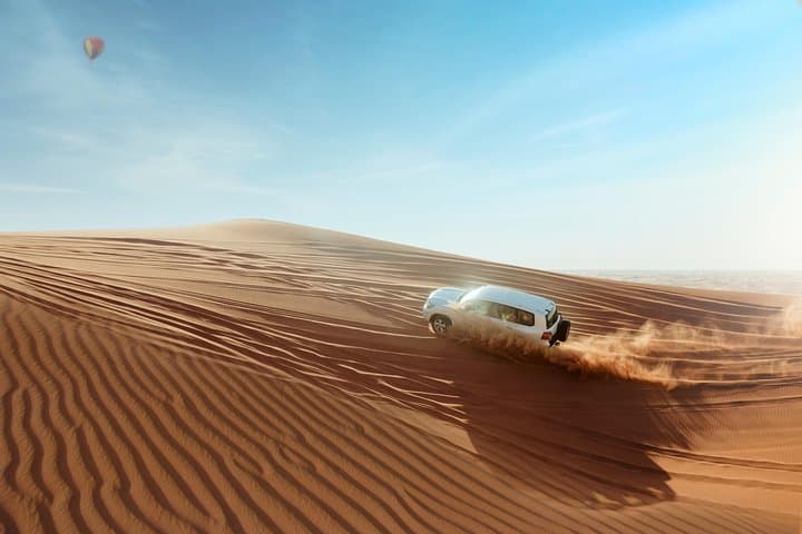 Evening Desert Safari in Dubai: Dune Bashing, Sandboarding & Bedouin Dinner