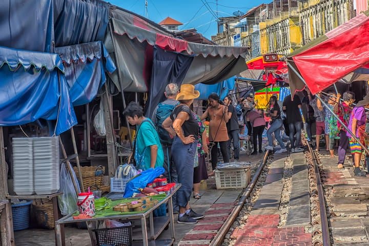 From Train Tracks to Emerald Pools: Damnoen Floating Market & Erawan Falls Day Tour photo 2