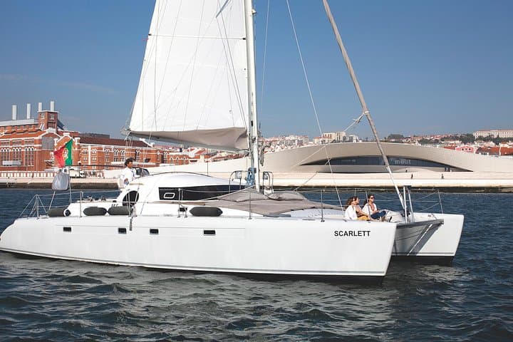 Sunset and City Sails: Private Catamaran Cruise on the Tejo aboard Scarlett