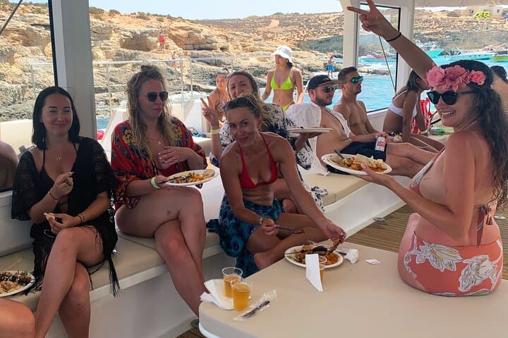 Blue Lagoon Evening Catamaran Cruise: Sunset Sailing to Comino's Turquoise Bays photo 4