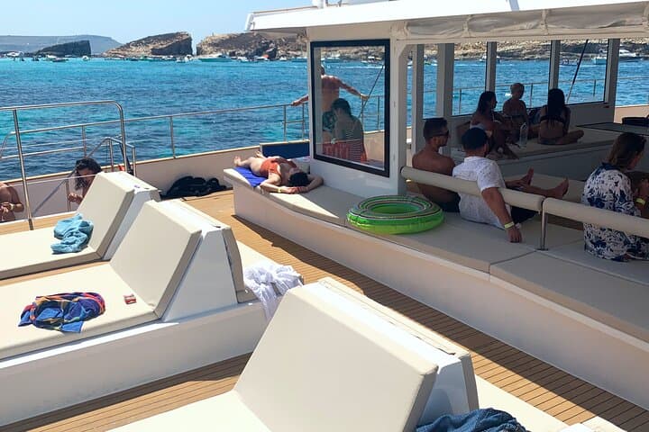 Blue Lagoon Evening Catamaran Cruise: Sunset Sailing to Comino's Turquoise Bays photo 5